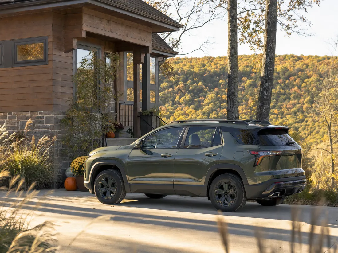 Compact SUV parked outside a hillside craftsman home in Fayetteville Arkansas with wooded Ozark ridges behind - selling a car in Fayetteville