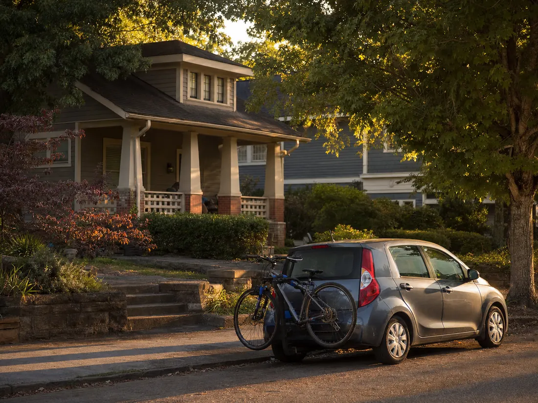 Compact hatchback with a bike rack outside a Craftsman cottage in an Athens college neighborhood - selling a car in Athens