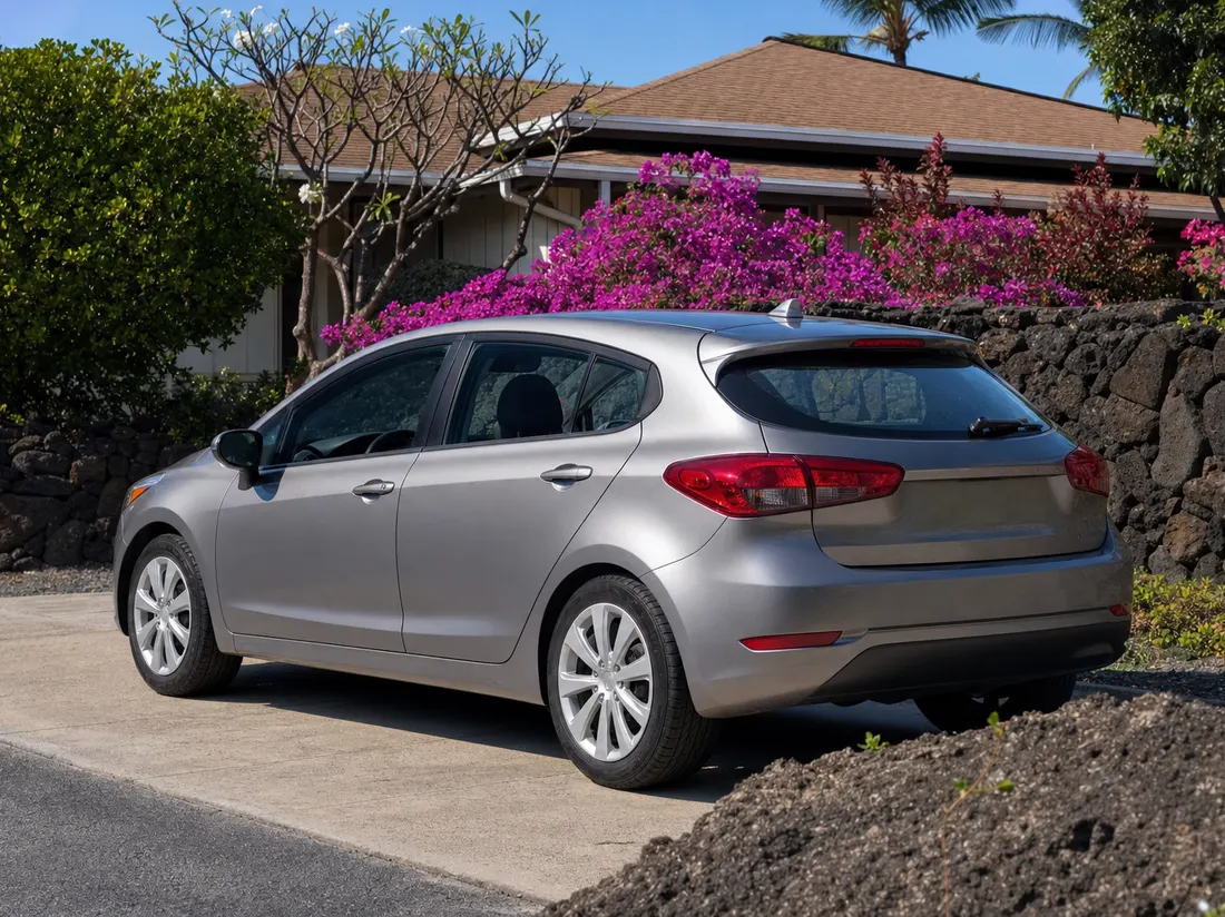 Hatchback parked by a Kailua-Kona Hawaii home with black lava-rock landscaping and bougainvillea - selling a car in Kailua Kona