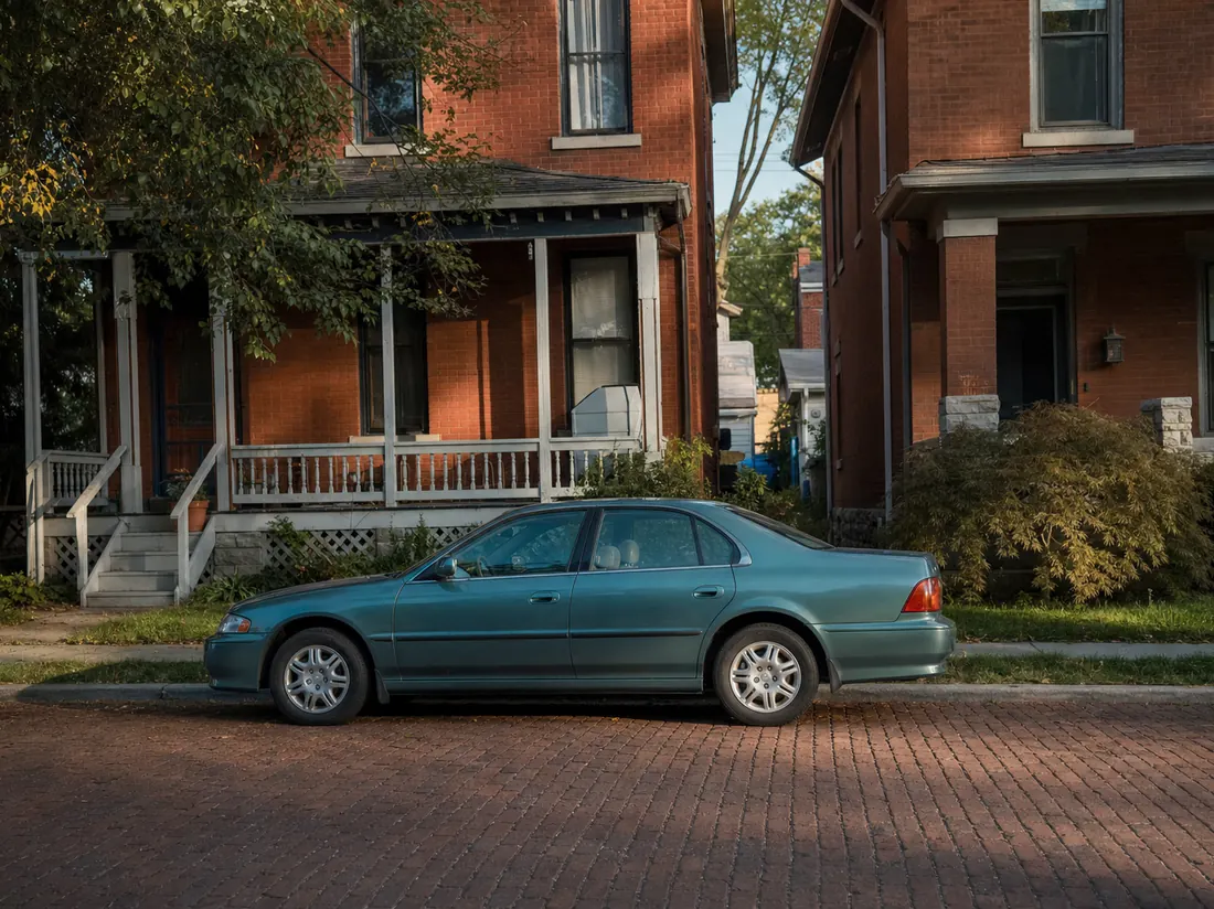 Sedan parked on a brick street of modest historic homes in Belleville - selling a car in Belleville