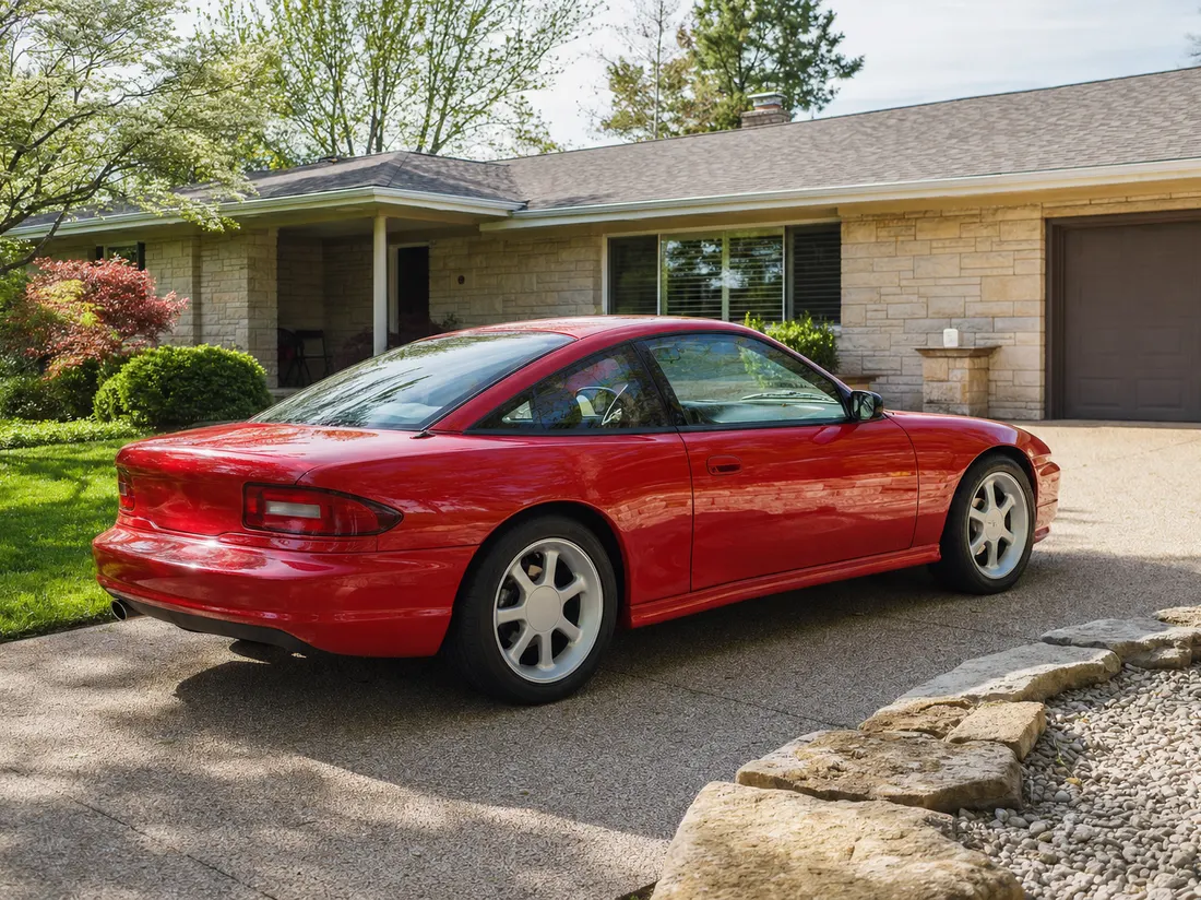Red coupe in the driveway of a neat ranch home in Bowling Green Kentucky with limestone landscaping - selling a car in Bowling Green