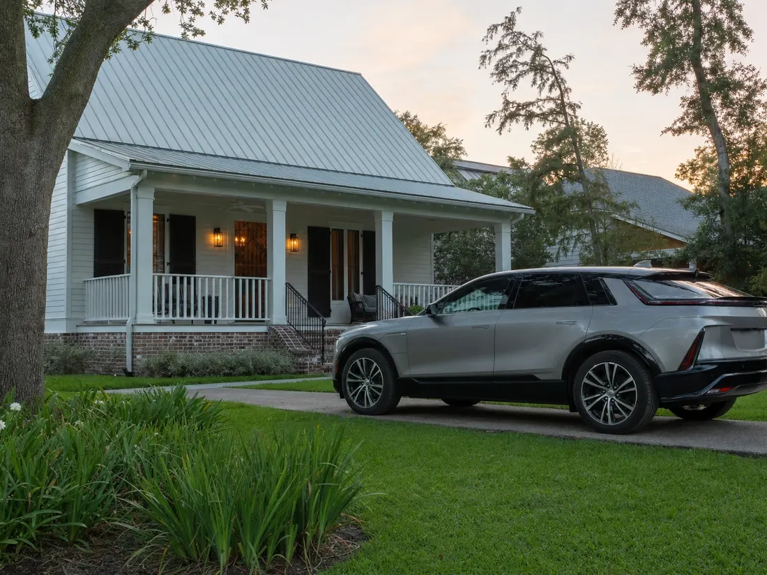 Crossover outside an Acadian-style home with a steep metal roof and front porch in Lafayette Louisiana - selling a car in Lafayette