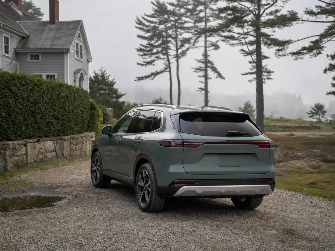 Crossover in the gravel driveway of a colonial farmhouse near Brunswick Maine with white pines and coastal morning fog burning off - selling a car in Brunswick