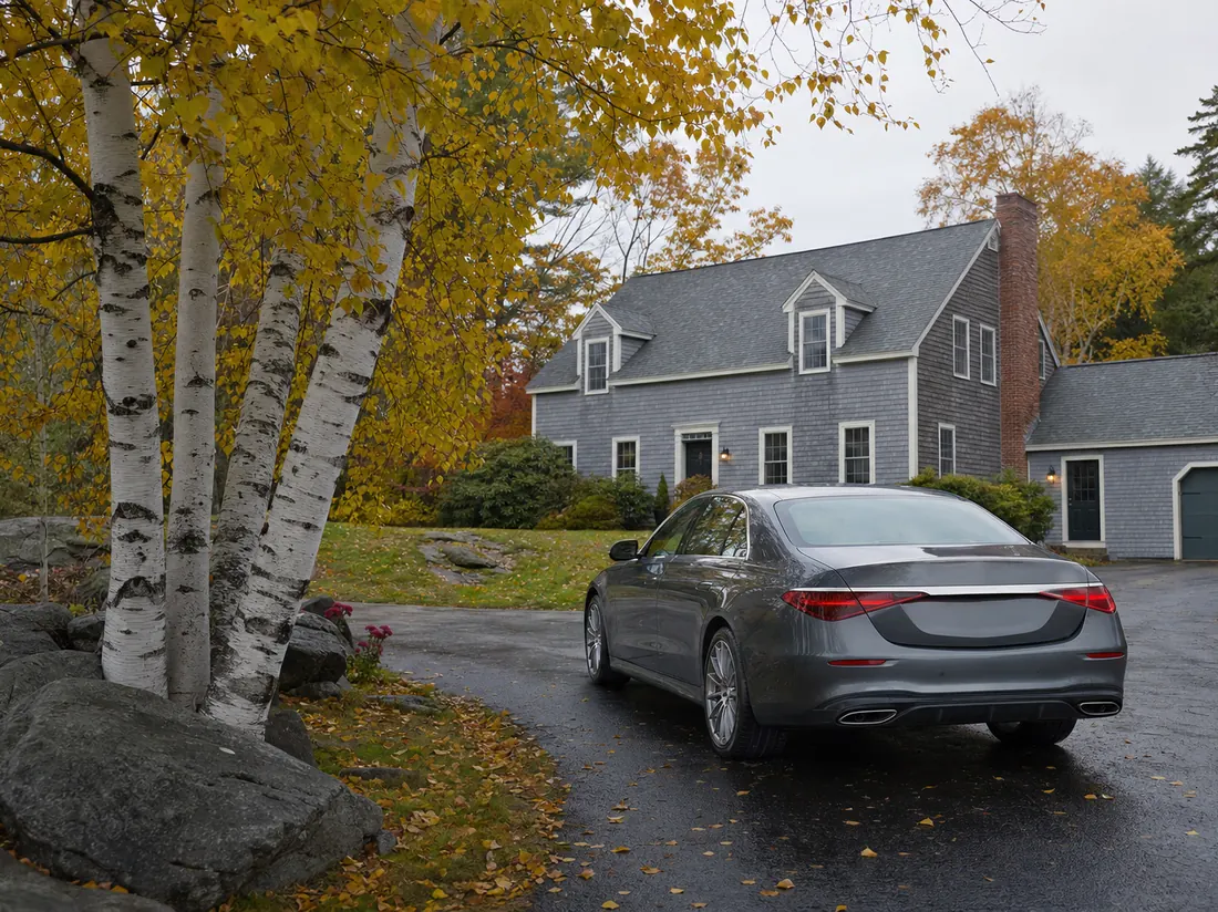 Sedan in the driveway of a New Hampshire cape-style home with white birches and granite outcrop, autumn color - selling a car in New Hampshire