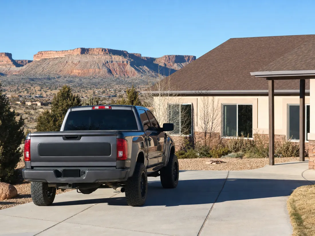 Pickup in the driveway of a ranch home in Farmington New Mexico with sandstone mesas on the horizon - selling a car in Farmington