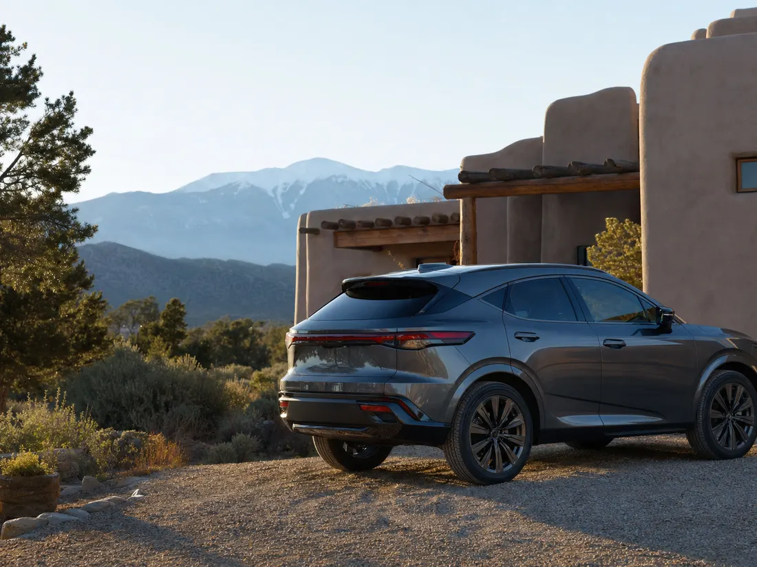 Crossover parked by an adobe-walled home in Santa Fe New Mexico with pinon trees and blue mountain light - selling a car in Santa Fe
