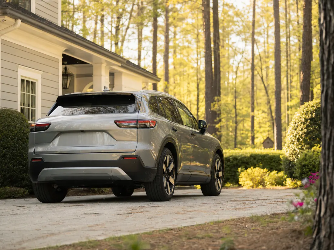 Crossover in a Raleigh driveway with tall pines and pollen-yellow light - selling a car in Raleigh