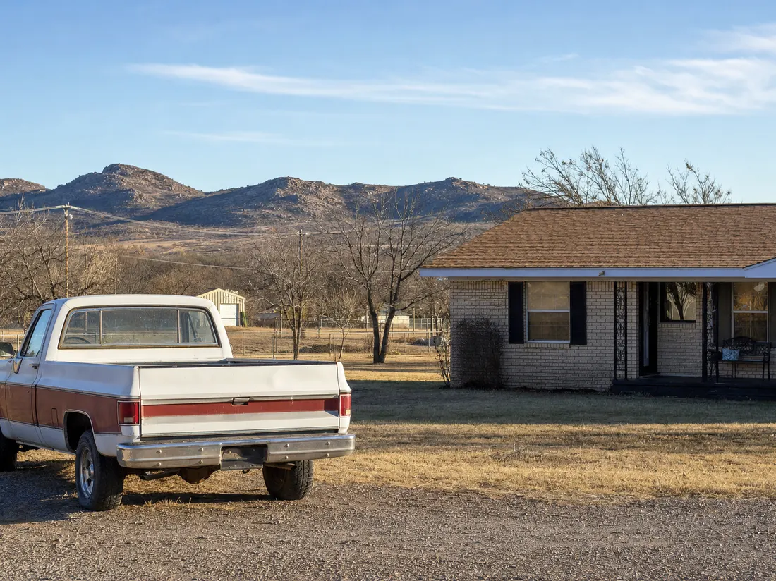 Older pickup beside a modest ranch home near Lawton Oklahoma with the granite Wichita Mountains low on the horizon - selling a car in Lawton