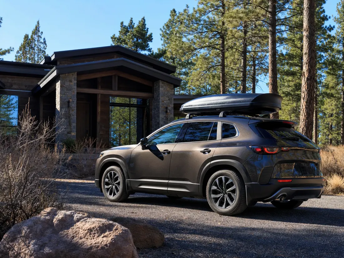 Crossover with a roof box outside a modern craftsman in Bend Oregon among ponderosa pines with high-desert light - selling a car in Bend