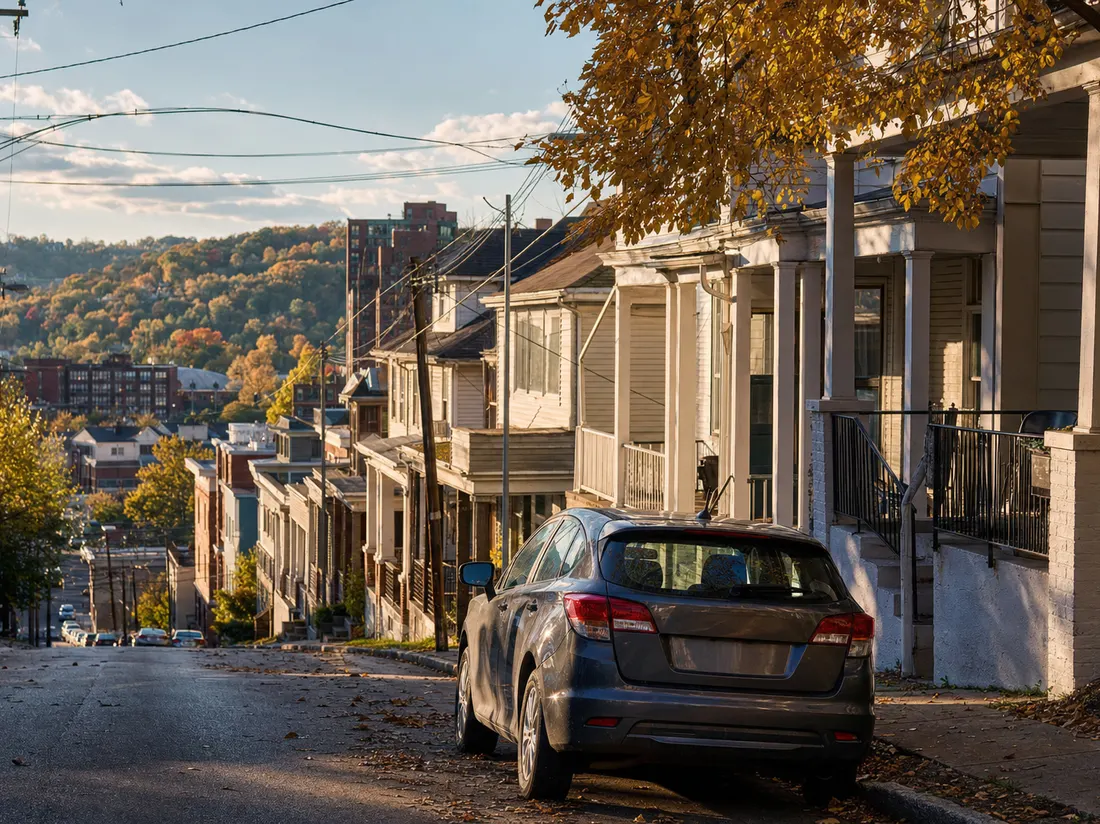 Hatchback parked on a steep student street in Morgantown West Virginia with porches stepping down the hill - selling a car in Morgantown