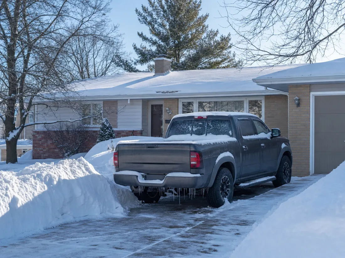 Pickup beside a ranch home in Green Bay Wisconsin with fresh snow banked along the driveway - selling a car in Green Bay