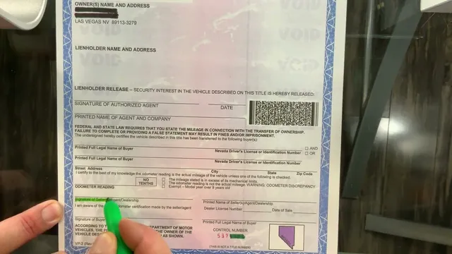 A Nevada certificate of title held against a window, a hand about to sign it with a green pen