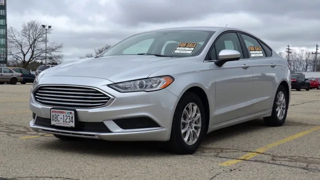 A silver saloon car with FOR SALE signs propped in its windows, parked on an empty lot under a grey sky - the opening frame of the WisDOT video on selling a vehicle privately.